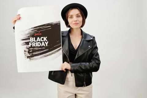 A woman holding a printed poster representing the oversize printing service offered